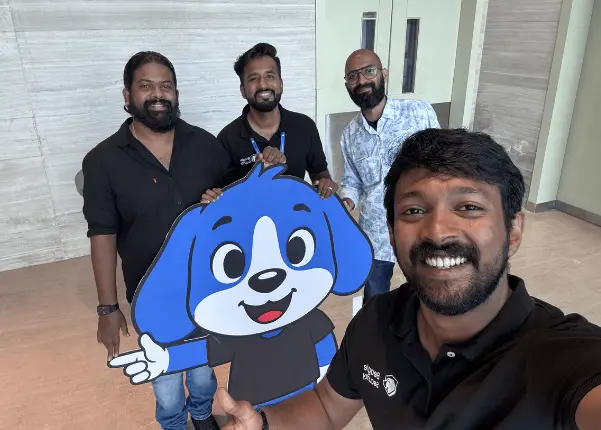A few team members take a selfie with the Beagle Security mascot Berry.