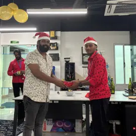 Team members receiving gifts from their secret Santa as part of the celebrations.