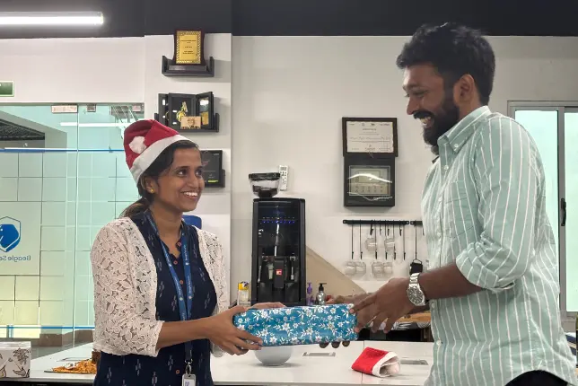 Team members receiving gifts from their secret Santa as part of the celebrations.