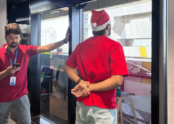 Employee holding tissue paper with breath in a fun challenge