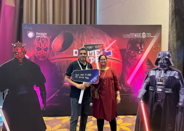 Pictures being taken in front of the star wars themed backdrop setup at DomeCTF 2023.