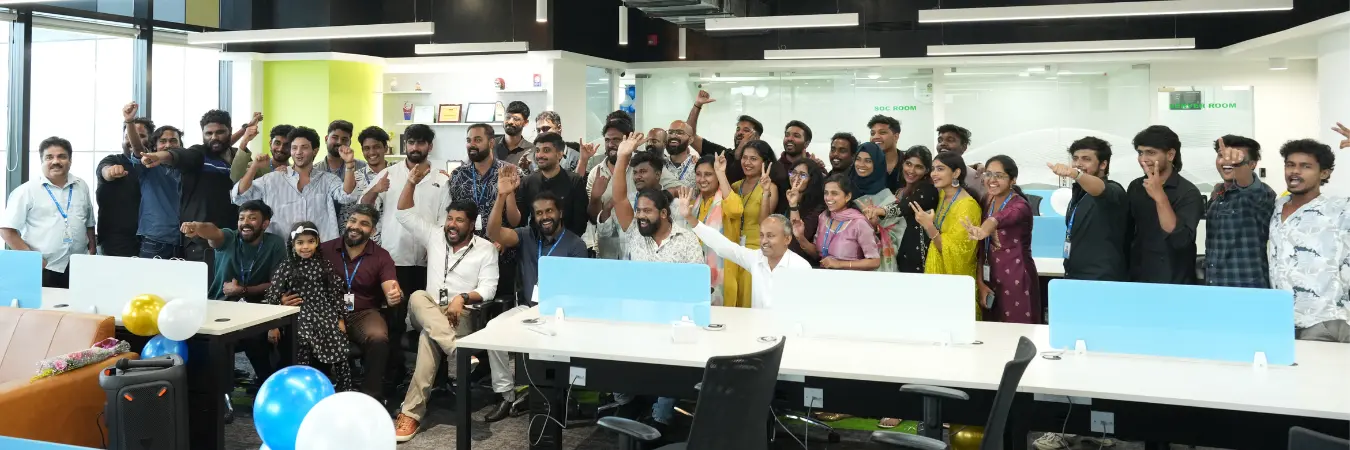 Team members in traditional wear posing for a group photo.