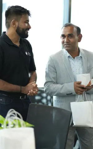 A Beagle team member engaged in conversation with one of the guests.