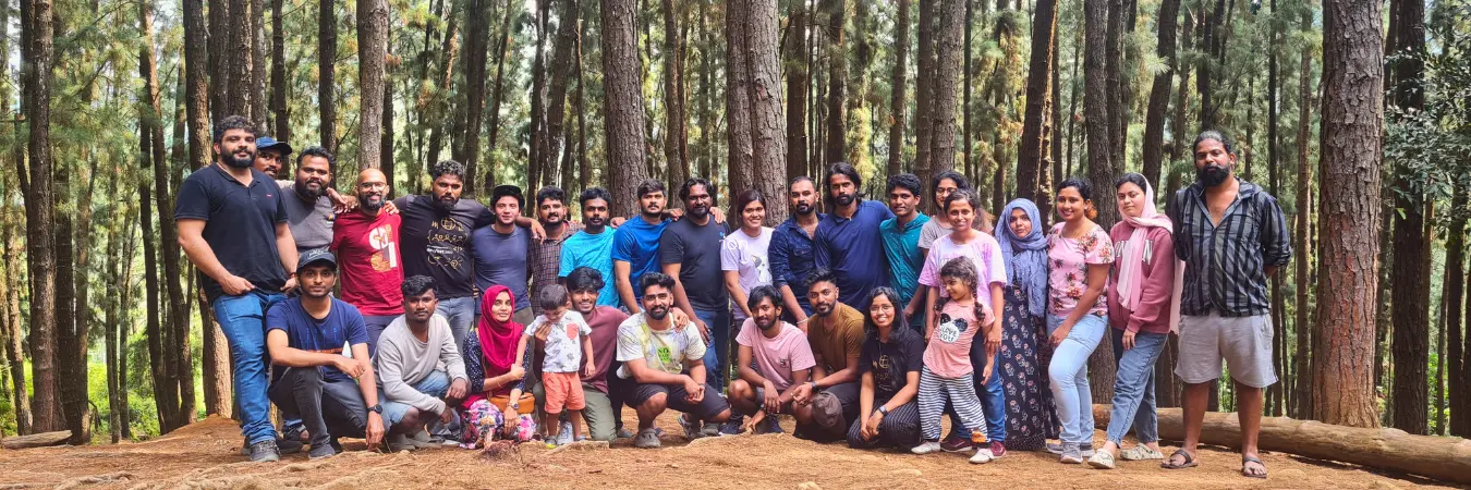 A group picture of the team among the pine trees of Pine Valley