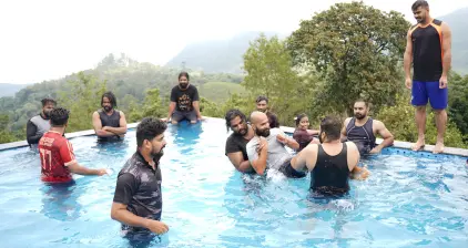 The team members having a fun time in the pool at the resort.