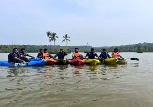 The team members of Beagle Security lined up on kayaks on the backwaters