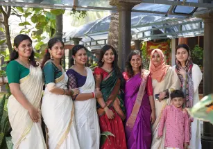 The ladies of Beagle Security pose for a pictures wearing saree.