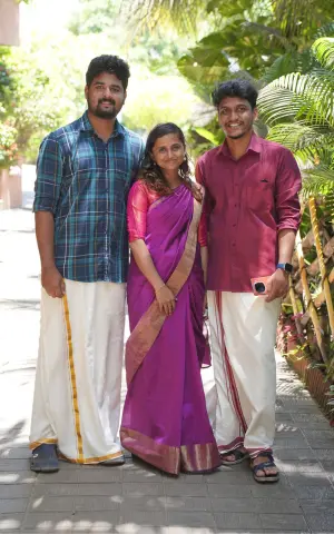 Team members wearing traditional dresses poses for a photo.