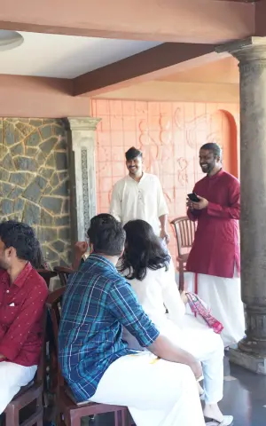 Team members participating in the traditional chair game during Onam celebrations