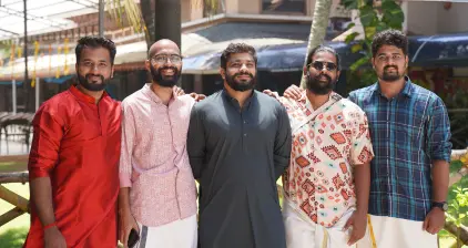 Team members posing for a pic in traditional attire.