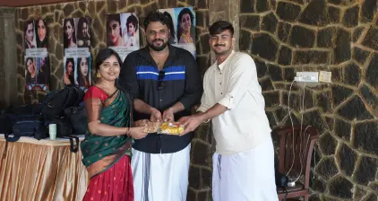 Team members sharing Onam sweets among each other.