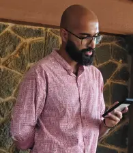 A team member looking through his phone for Onam tunes