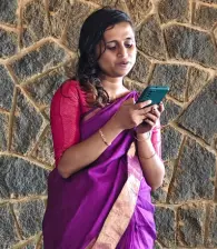 A team member looking through his phone for Onam tunes