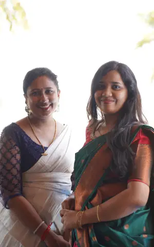 Two team members wearing colorful sarees.