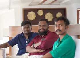 =Beagle Security members at Ashtamudi lake on a boat.
