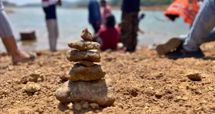 A tiny rock tower created along the banks of the Thenmala reservoir by one of the team members.