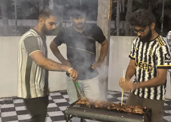 A few team members helping out by grilling the chicken.