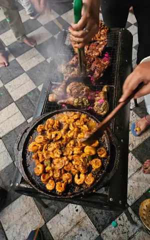 Pan-frying the prawns on the grill.