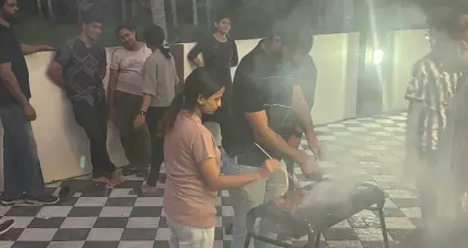 Smoke rising from the grill as the chicken is prepared.