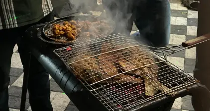 A variety of meat on the grill to be cooked.