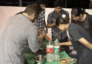 A few team members getting the tasty naan ready for a combo with the grilled chicken.