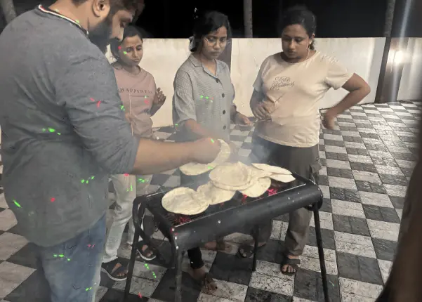 Some team members charring the naan for some added flavor.